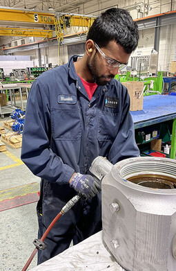 Assembly employee repairing an Argus Pig Valve